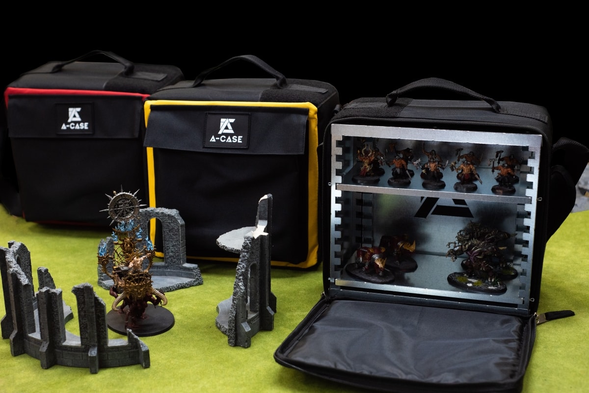Three A-Case models with painted miniatures ready for transport